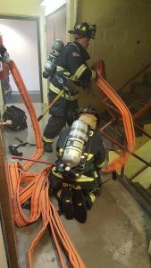 Firefighters Rolling out the Hose